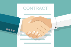Buyer and seller handshake in front of a contract